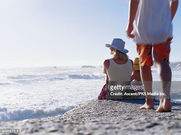 family watching surf at camps bay, cape town, south africa - cape province stock pictures, royalty-free photos & images