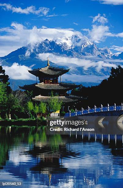 pagoda reflected in black dragon pool in front of jade dragon snow mountain (mt satseto), lijiang, china - semi precious gem stock pictures, royalty-free photos & images