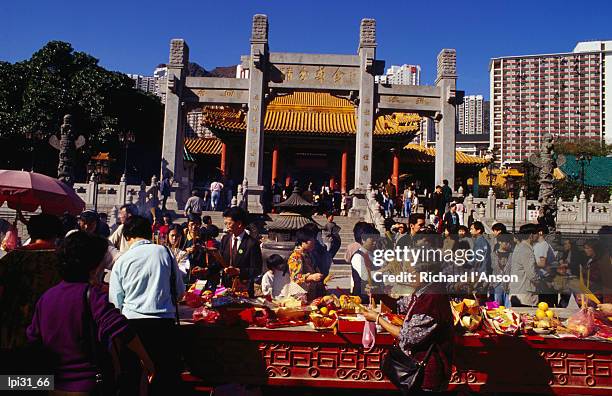 crowds of people giving offerings in grounds of wong tai sin temple, kowloon, hong kong, china, north-east asia - tai stock pictures, royalty-free photos & images