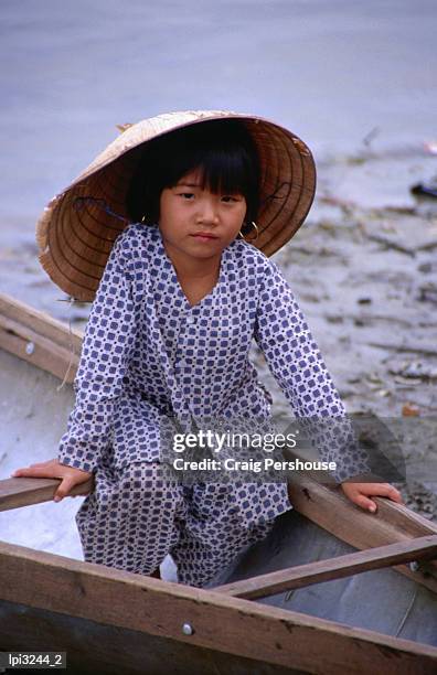 girl in canoe by perfume river, looking at camera, front view, hue, vietnam - craig pershouse stock pictures, royalty-free photos & images