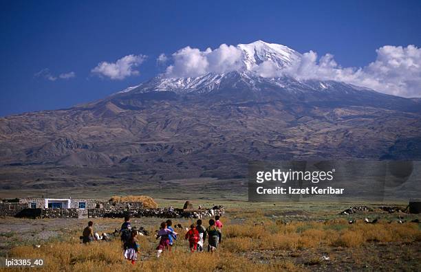 children running and mt ararat, rear view, agri, turkey - dormant volcano stock-fotos und bilder