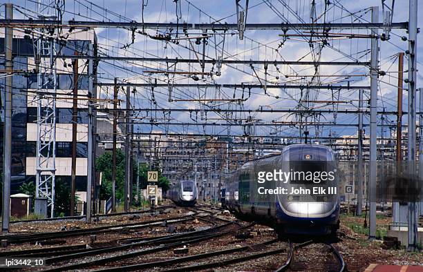 tgv high-speed train traveling along c1ty tracks, paris, france - high speed train stock-fotos und bilder