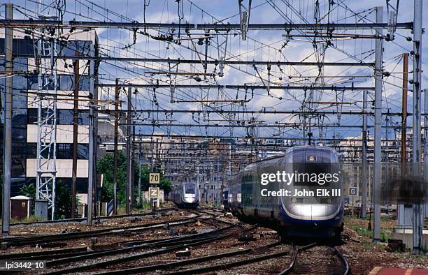 tgv high-speed train traveling along c1ty tracks, paris, france - tgv stockfoto's en -beelden