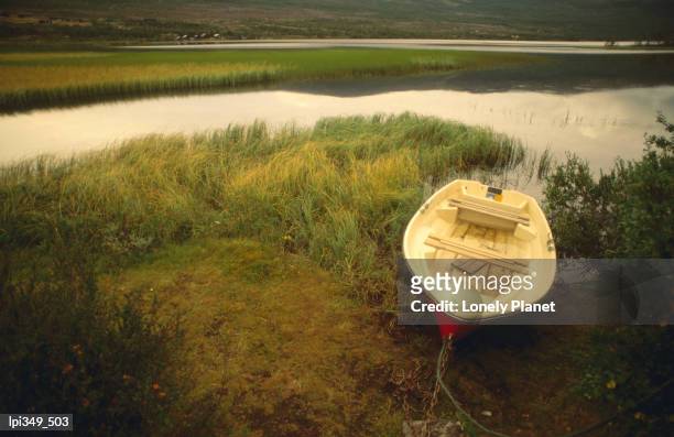 boat beside lake at sunset. - trøndelag stock pictures, royalty-free photos & images
