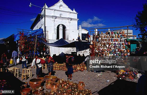 capilla del calvario church in main square with market stalls in foreground, chichicastenango, quiche, guatemala, central america & the caribbean - capilla stock pictures, royalty-free photos & images