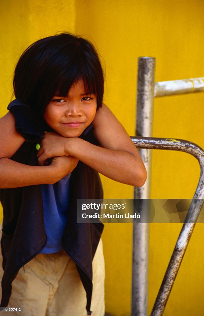 Portrait of Lao girl at entrance to Wat St Muang, Vientiane, Vientiane Prefecture, Laos, South-East Asia