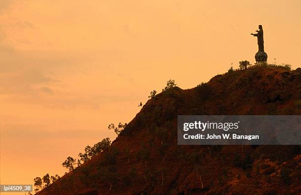 christ statue at dusk, low angle view, dili, east timor - dili stock-fotos und bilder