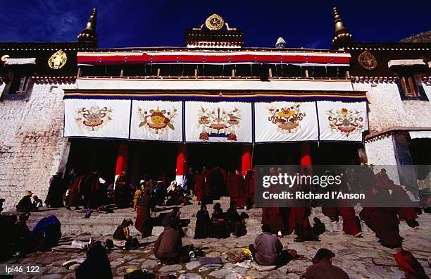 monks and pilgrims outside sera monastery, lhasa, tibet, china, north-east asia - tibet autonomous region stock pictures, royalty-free photos & images