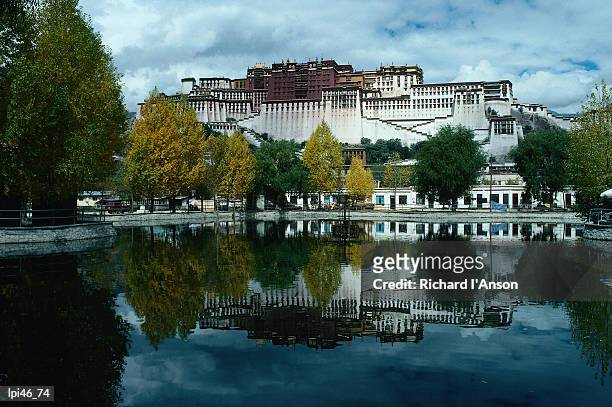 view of impressive potala palace and lake in chingdrol chiling (liberation park), lhasa, tibet, china, north-east asia - autonoma regionen tibet bildbanksfoton och bilder