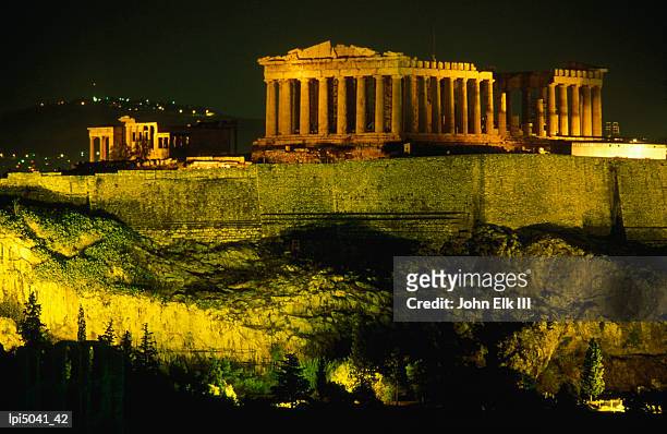 the acropolis at night taken from phiopappos hill, side view, athens, greece - central greece stock pictures, royalty-free photos & images