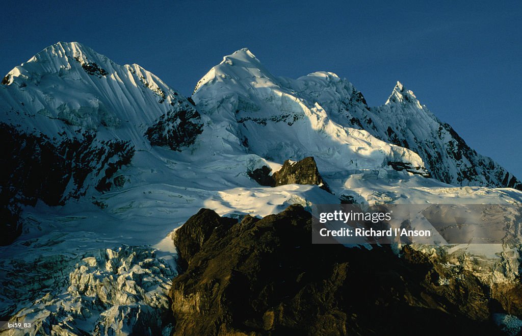Snow covered mountain peaks in light of setting sun, Vilcanota, Cuzco, Peru, South America