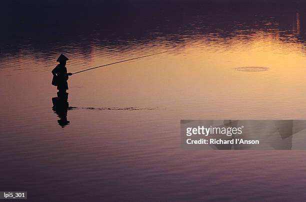 fisherman silhouetted at sunrise, sanur, bali, indonesia, south-east asia - sunda isles bildbanksfoton och bilder
