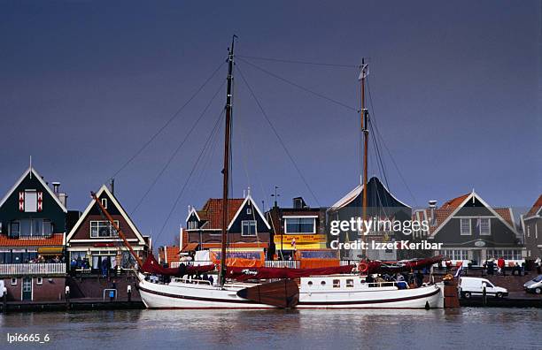 waterfront houses and boats, low angle view, volendam, netherlands - volendam photos et images de collection