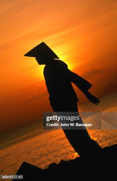 silhouette of woman exercising on beach at sunset, nha trang, khanh hoa, vietnam, south-east asia - banagan stock pictures, royalty-free photos & images