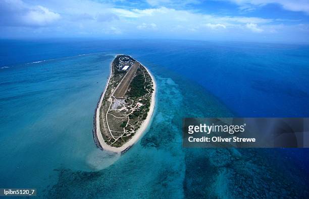 aerial view of the island, also known locally as poruma, surrounded by shallow coral reefs., coconut island, queensland, australia, australasia - travel2 stock pictures, royalty-free photos & images