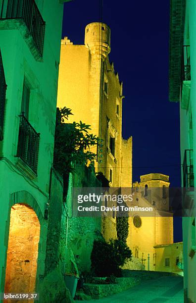 church and castle of sant marti illuminated at night, altafulla., tarragona, catalonia, spain, europe - travel2 stock pictures, royalty-free photos & images
