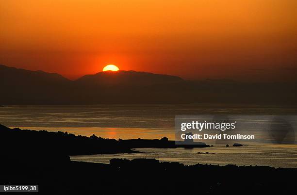 sunset over the costa del sol and the ancient watchtower (atalaya) at estepona., malaga, andalucia, spain, europe - costa stock pictures, royalty-free photos & images