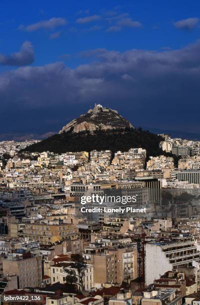 lykavittos hill and city, with storm clouds brewing overhead., athens, attica, greece, europe - zentralgriechenland stock-fotos und bilder