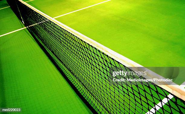 tennis net on a green court - tennis court stock pictures, royalty-free photos & images