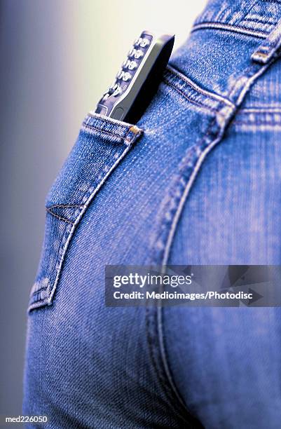 mobile phone in a person's back pocket - phone in back pocket stock pictures, royalty-free photos & images