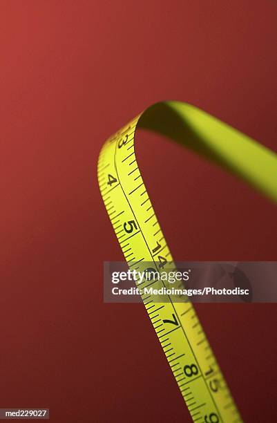 a bent measuring tape - metric system stock pictures, royalty-free photos & images