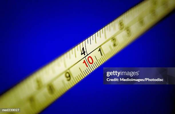 close-up of a measuring tape - metric system stock pictures, royalty-free photos & images
