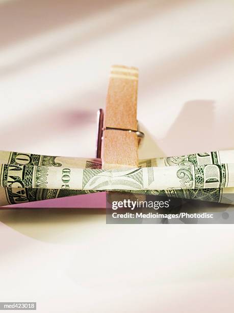 clothes peg holding american bank notes - peg stock pictures, royalty-free photos & images