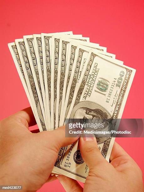 person's hand holding american bank notes - fan shape stock pictures, royalty-free photos & images