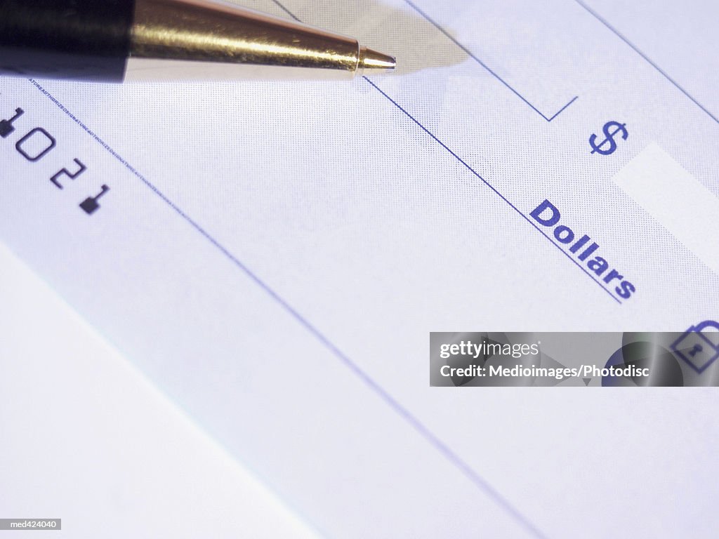 Pen over a blank check