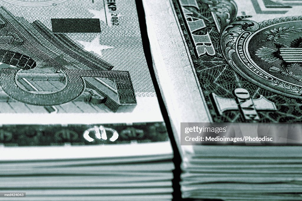 Stacks of American and Euro bank notes