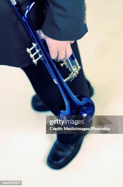 man holding a trumpet, tilt - bläser stock-fotos und bilder