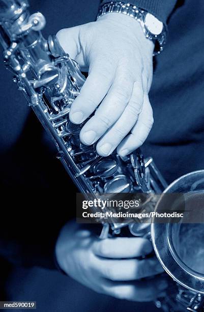 man playing a saxophone, close-up, part of - bläser stock-fotos und bilder