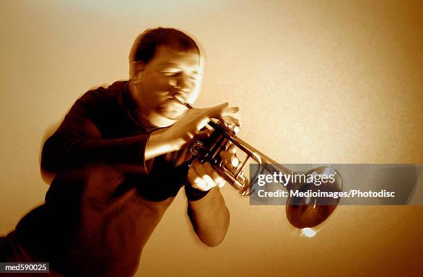 man playing a trumpet - bläser stock-fotos und bilder