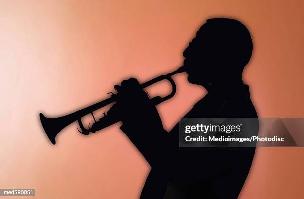 man playing a trumpet - bläser stock-fotos und bilder