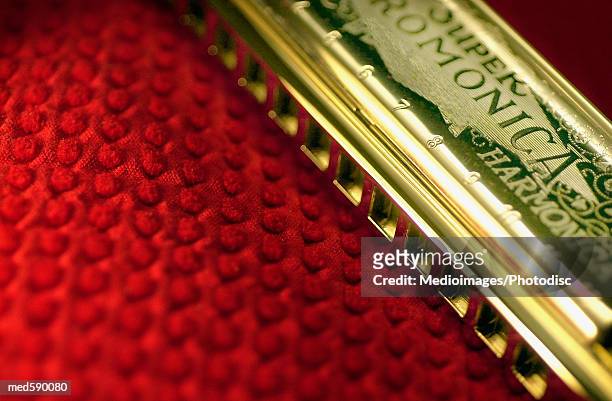 harmonica on red cloth - harmonica stock pictures, royalty-free photos & images