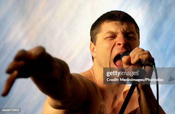 singer with microphone - modern rock stock pictures, royalty-free photos & images