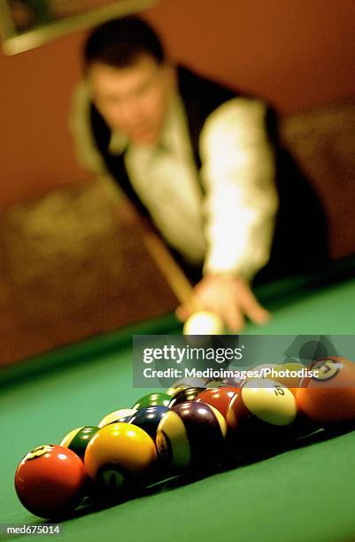 man preparing to break billiard balls, close-up, selective focus - snooker break stock pictures, royalty-free photos & images