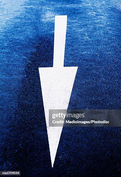 arrow sign on road, close-up - generic safety sign stock pictures, royalty-free photos & images