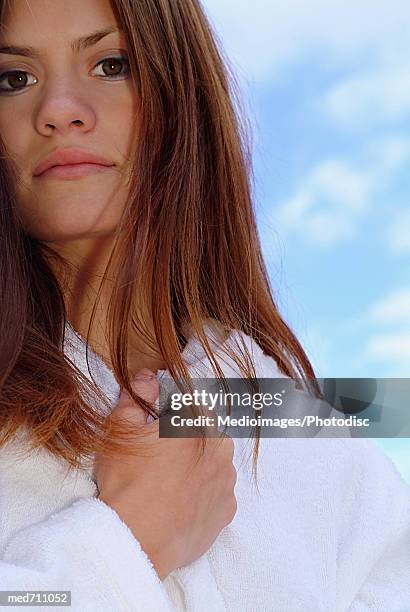 Pensive Woman With Hand At Neck And Wearing Bathroom Outdoors Closeup High-Res Stock Photo