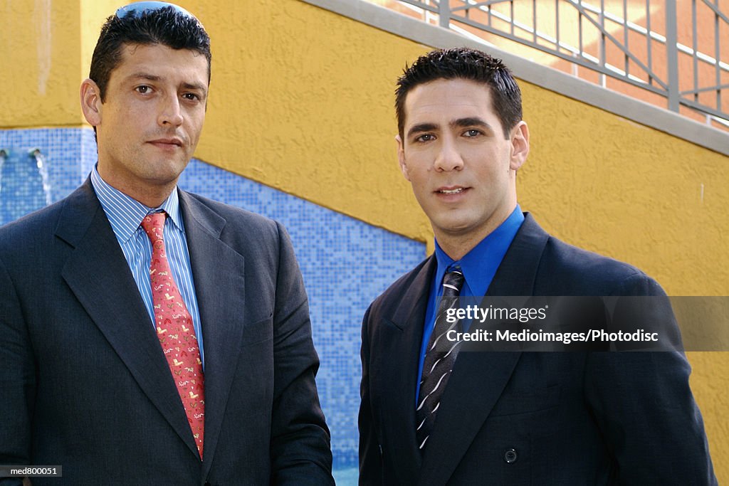 Portrait of two businessmen looking at camera