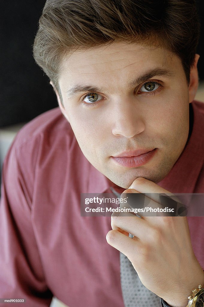 Portrait of businessman with hand on his chin