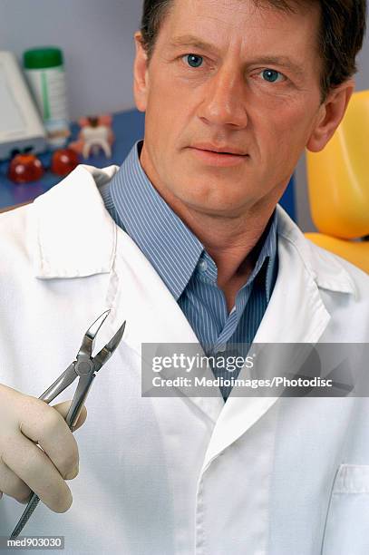 male dentist with pliers, close-up, part of, selective focus - modell stock pictures, royalty-free photos & images