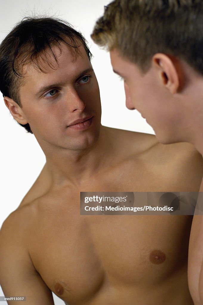 Young male couple looking at each other