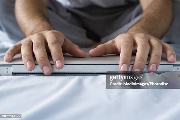 human hands on a laptop - closing laptop stock pictures, royalty-free photos & images