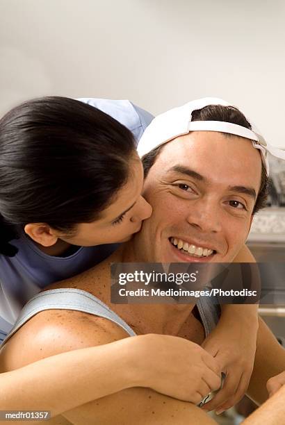 young woman kissing man on check - check up ストックフォトと画像