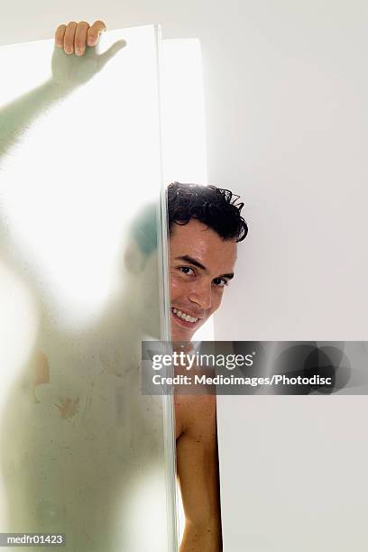 young man coming out of shower stall - people coming of age purify with icy water in tokyo stockfoto's en -beelden