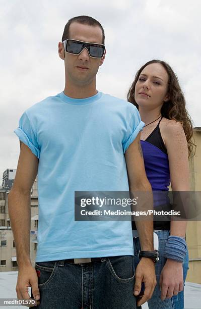 portrait of a young couple standing outdoors - female body piercing fotografías e imágenes de stock