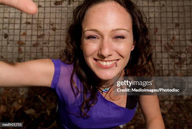 woman raising her arm and smiling - finger waves ストックフォトと画像