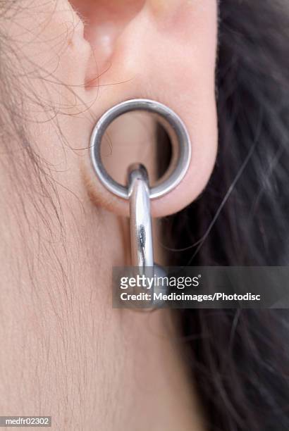 close-up of a persons pierced earlobe - earlobe ストックフォトと画像