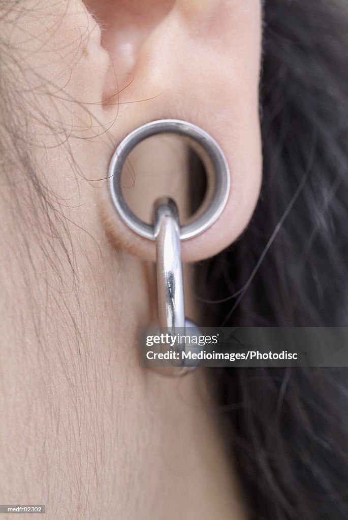 Close-up of a persons pierced earlobe